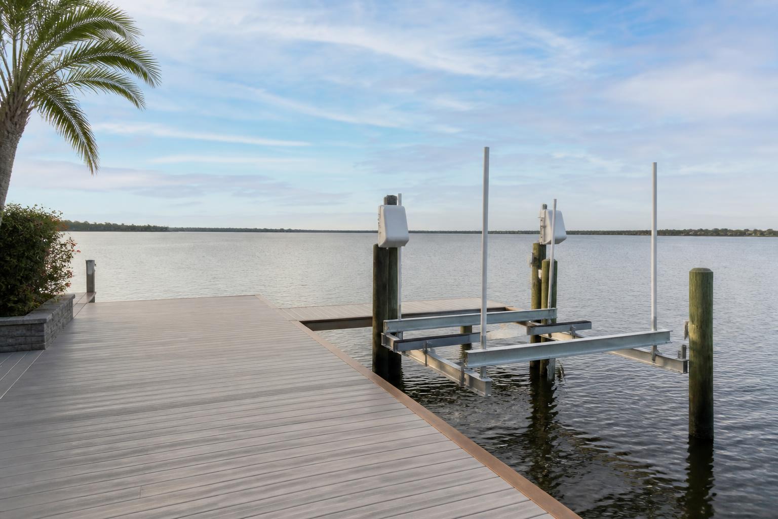 Clean marina dock with repaired boat lift and open water.